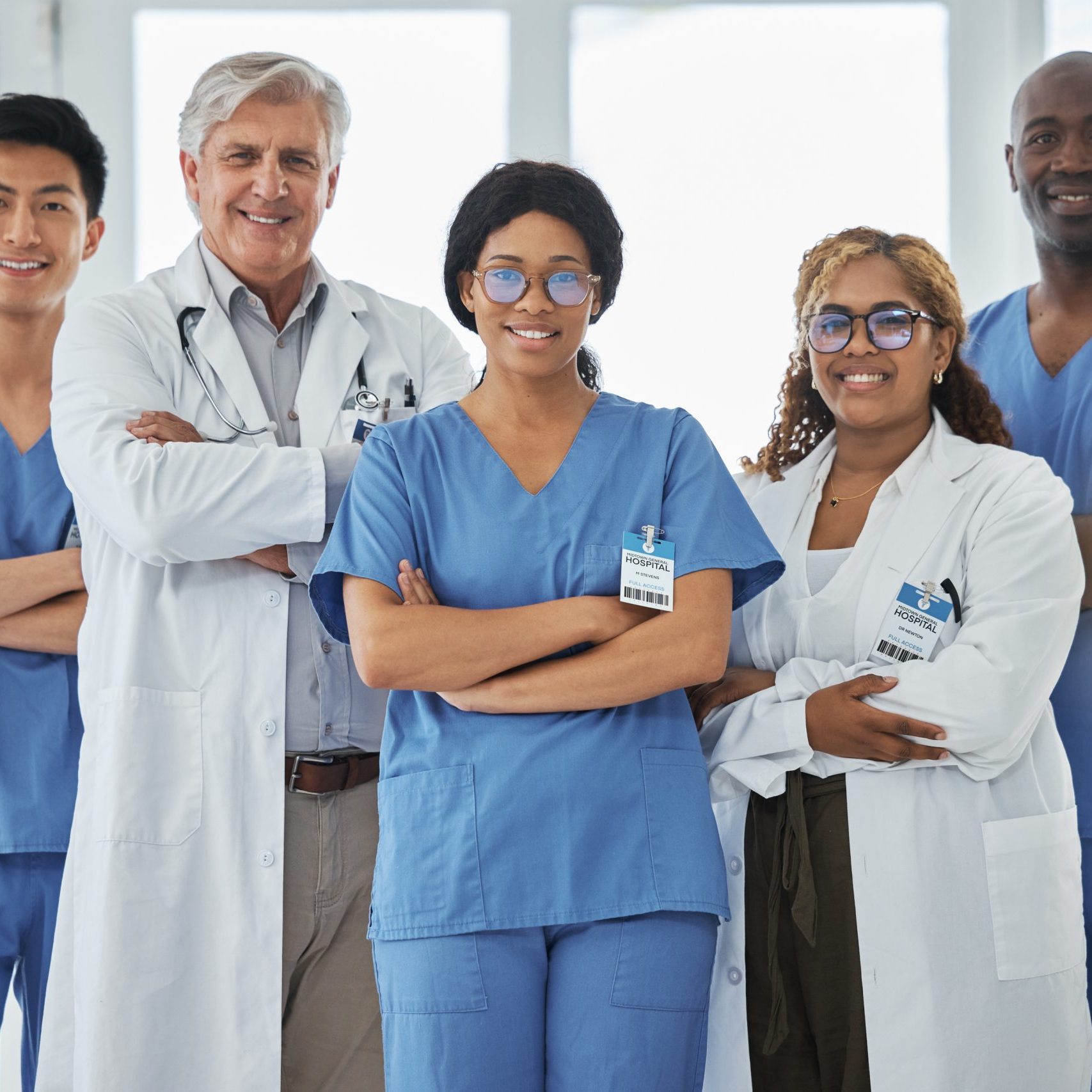 Nurses, portrait and team of doctors with arms crossed standing together in hospital. Face, confident and medical professionals, surgeons or group with healthcare collaboration, teamwork and happy